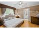 Cozy bedroom features a large bed, wood floors, neutral colors and an ensuite bathroom at 681 Hampton Sw Pl, Marietta, GA 30064