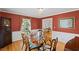 Charming dining room with red walls, wood floors, chandelier, and classic furniture at 681 Hampton Sw Pl, Marietta, GA 30064