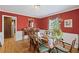 Traditional dining room with hardwood floors, red walls, chandelier, and classic wood furniture at 681 Hampton Sw Pl, Marietta, GA 30064