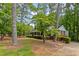 Inviting brick home with lush green landscaping, mature trees, and a classic, timeless architectural design at 681 Hampton Sw Pl, Marietta, GA 30064