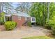 Traditional brick home with a well-manicured lawn, surrounded by mature trees offering privacy and curb appeal at 681 Hampton Sw Pl, Marietta, GA 30064