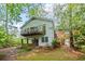 Charming home with a balcony on the second level and a covered porch on the first, surrounded by lush trees at 681 Hampton Sw Pl, Marietta, GA 30064