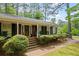 Inviting front porch with classic brick steps and a decorative front door, exuding charm and curb appeal at 681 Hampton Sw Pl, Marietta, GA 30064