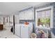 Laundry room with white appliances, cabinets, and blue floral wallpaper, combined with natural light at 681 Hampton Sw Pl, Marietta, GA 30064