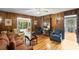 Cozy living room with wood-paneled walls, plush seating, and access to a sunroom, offering a relaxing retreat at 681 Hampton Sw Pl, Marietta, GA 30064