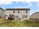 Backyard with green grass, patio set, and gray siding on the two-story home at 1612 Nations Trl, Riverdale, GA 30296