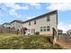 An expansive backyard features green lawn and a patio set, with a two-story home at 1612 Nations Trl, Riverdale, GA 30296