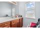 Bathroom featuring wood cabinets, sink, and natural light from window at 1612 Nations Trl, Riverdale, GA 30296