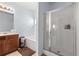 This bathroom features a vanity with warm wood cabinets, a soaking tub, and a glass enclosed shower at 1612 Nations Trl, Riverdale, GA 30296