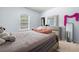 Bedroom with a plush bed, carpet flooring, and dresser with mirror at 1612 Nations Trl, Riverdale, GA 30296
