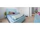 A blue bedroom with a blue bed and nightstand with carpeted floors at 1612 Nations Trl, Riverdale, GA 30296