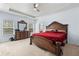 Primary bedroom featuring a tray ceiling, a ceiling fan and carpet flooring at 1612 Nations Trl, Riverdale, GA 30296