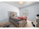 Bedroom with a plush bed, carpet flooring, and natural lighting at 1612 Nations Trl, Riverdale, GA 30296