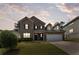 Beautiful two-story brick home featuring a well-manicured lawn and a two-car garage at dusk at 1612 Nations Trl, Riverdale, GA 30296