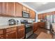 Modern kitchen features stainless steel appliances, granite counters, and hardwood flooring at 1612 Nations Trl, Riverdale, GA 30296