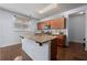 Well-lit kitchen with granite counters, wood cabinets, stainless steel faucet, and hardwood flooring at 1612 Nations Trl, Riverdale, GA 30296