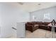 Cozy living room with a brown couch and a view of the staircase at 1612 Nations Trl, Riverdale, GA 30296