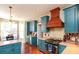 Well-lit kitchen featuring blue cabinets, stainless steel appliances, and a breakfast nook with bay window at 190 Country Club Dr, Hiram, GA 30141