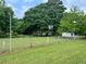 Large backyard with a chainlink fence and mature trees at 2659 Odum St, Snellville, GA 30078