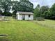 Garage with tidy yard and bird bath surrounded by chainlink fencing at 2659 Odum St, Snellville, GA 30078