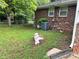 Backyard view with brick exterior, mature trees, and well-maintained yard at 2659 Odum St, Snellville, GA 30078