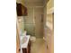 Compact bathroom featuring tiled shower, toilet, vanity, and window at 2659 Odum St, Snellville, GA 30078