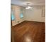 Spacious bedroom with hardwood floors, a ceiling fan, and natural light from two windows at 2659 Odum St, Snellville, GA 30078