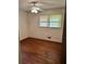 A bedroom with hardwood floors, a ceiling fan, and a window with natural light at 2659 Odum St, Snellville, GA 30078