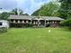 Charming brick home with a well-maintained front yard and mature landscaping, creating a welcoming curb appeal at 2659 Odum St, Snellville, GA 30078