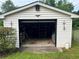 Open one-car garage with white siding and an eagle emblem at 2659 Odum St, Snellville, GA 30078