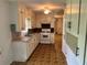 Bright kitchen featuring white cabinets, a double sink, white stove and linoleum flooring at 2659 Odum St, Snellville, GA 30078