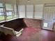 Enclosed patio featuring a porch swing, brick accents, and natural light at 2659 Odum St, Snellville, GA 30078