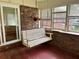 Enclosed porch featuring a swing seat, brick details, and lots of natural light at 2659 Odum St, Snellville, GA 30078