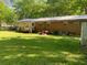 Large backyard with a deck and green grass at 3683 Miller St, Lithia Springs, GA 30122