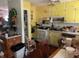 Kitchen with yellow cabinets and white appliances at 3683 Miller St, Lithia Springs, GA 30122
