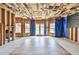 Unfinished basement with exposed ceiling and walls, windows, and French doors to the backyard at 2727 Lost Mill Trce, Buford, GA 30519