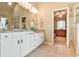 Bright bathroom with granite countertops, double sinks, a large mirror and tile flooring at 2727 Lost Mill Trce, Buford, GA 30519
