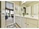 Bathroom with double sink vanity and an open doorway to the living room at 2727 Lost Mill Trce, Buford, GA 30519