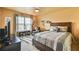 Cozy bedroom with a large bed, ceiling fan, and natural light at 2727 Lost Mill Trce, Buford, GA 30519