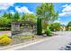 Stone community sign reading 'The Shoals at Bogan's Bridge' with lush landscaping and a glimpse of neighborhood homes at 2727 Lost Mill Trce, Buford, GA 30519