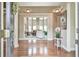 Elegant foyer with hardwood floors and an open view to the living room featuring large windows at 2727 Lost Mill Trce, Buford, GA 30519