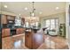 The spacious kitchen has hardwood floors, granite counters, island with bar, and stainless appliances at 2727 Lost Mill Trce, Buford, GA 30519