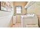Well-lit laundry room with washer, dryer, and shelving at 2727 Lost Mill Trce, Buford, GA 30519