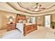 A spacious primary bedroom features tray ceilings, carpet flooring, and neutral paint at 2727 Lost Mill Trce, Buford, GA 30519