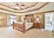 The main bedroom features a tray ceiling, carpet flooring, and a large window at 2727 Lost Mill Trce, Buford, GA 30519