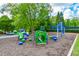 Community playground with colorful play structures, wood chip ground cover and mature trees at 2727 Lost Mill Trce, Buford, GA 30519