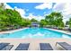 Community pool with lounge chairs, clear blue water and blue skies with trees at 2727 Lost Mill Trce, Buford, GA 30519