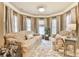A sitting room features plush sofas, a decorative rug, and large windows providing natural light at 2727 Lost Mill Trce, Buford, GA 30519
