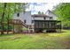 Exterior view of house from the back with large backyard and deck at 3880 Northpoint Dr, Marietta, GA 30062