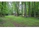 Spacious backyard features mature trees, storage shed and a deck at 3880 Northpoint Dr, Marietta, GA 30062